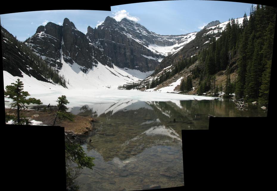 Lake Agnes viewed from the bridge over the outlet river. Most of it was still covered in snow. (June)